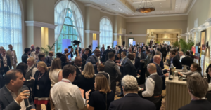 a crowd of people crammed into a hallway networking